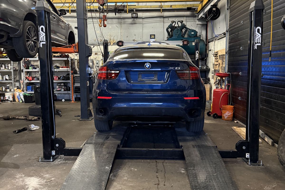 BMW X6 on the alignment rack at Royal Fix Auto Repair